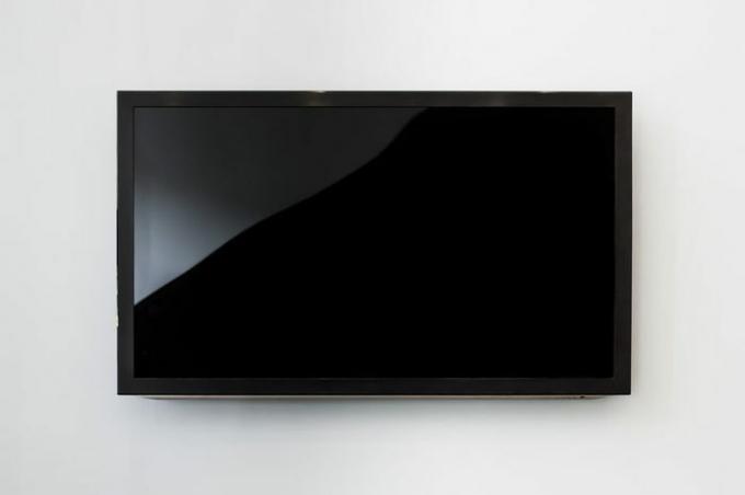 Fekete LED TV televízió képernyő makett / modell, üres fehér fal háttér