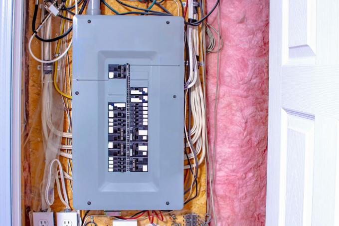 caja de interruptores en una pared con cables y aislamiento