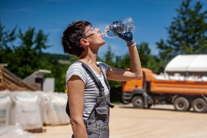 Tørstig kvindelig arbejder i malmforarbejdningsanlæg
